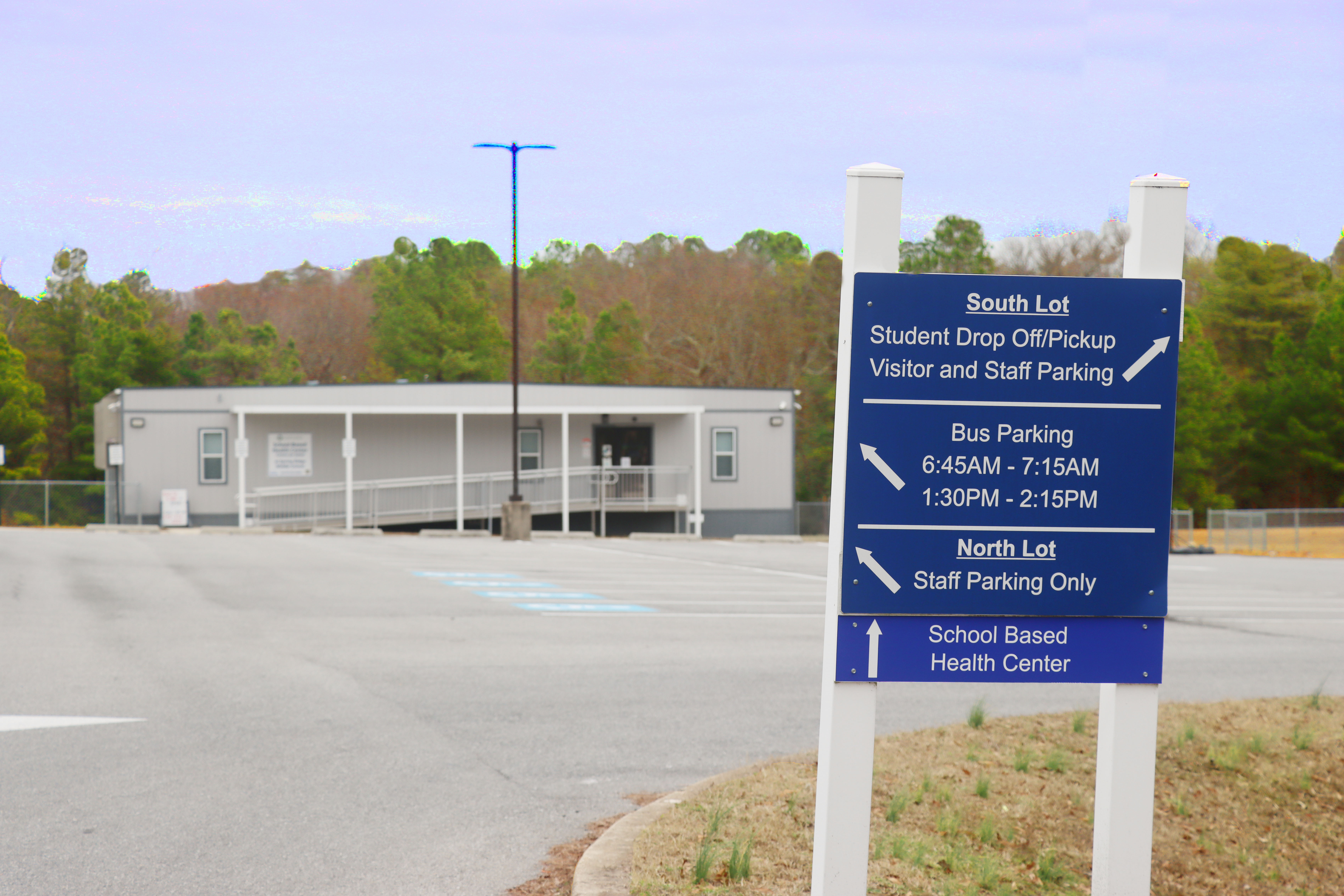 Spring Ridge Middle School Based Health Center with directional sign in parking lot